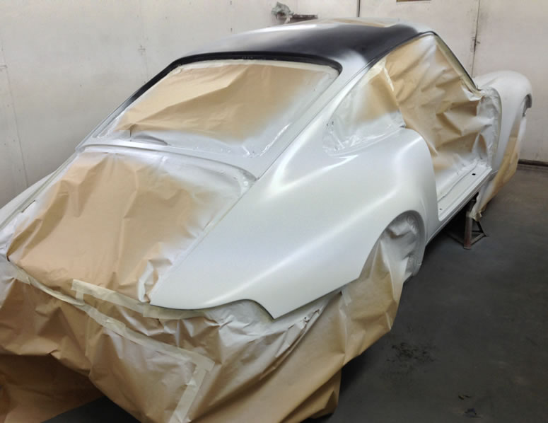 Piccture of a vintage car that is being sprayed as part of body work at John Bee Ltd